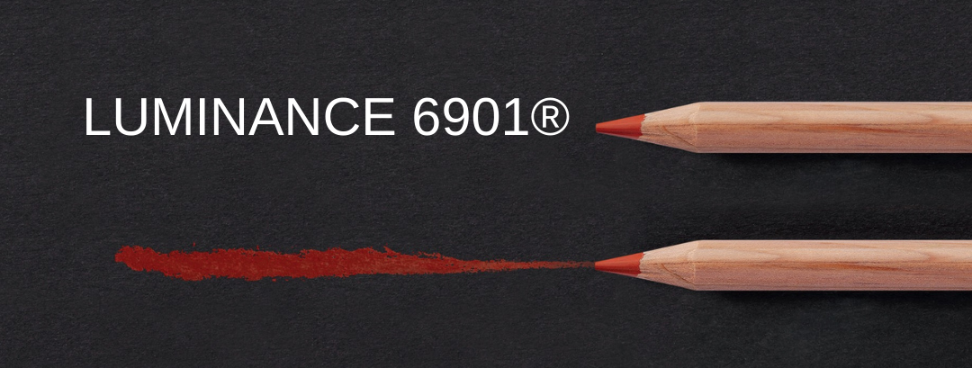 Caran d’Ache Luminance 6901 lightfast coloured pencils drawing a rich red line on a black background banner