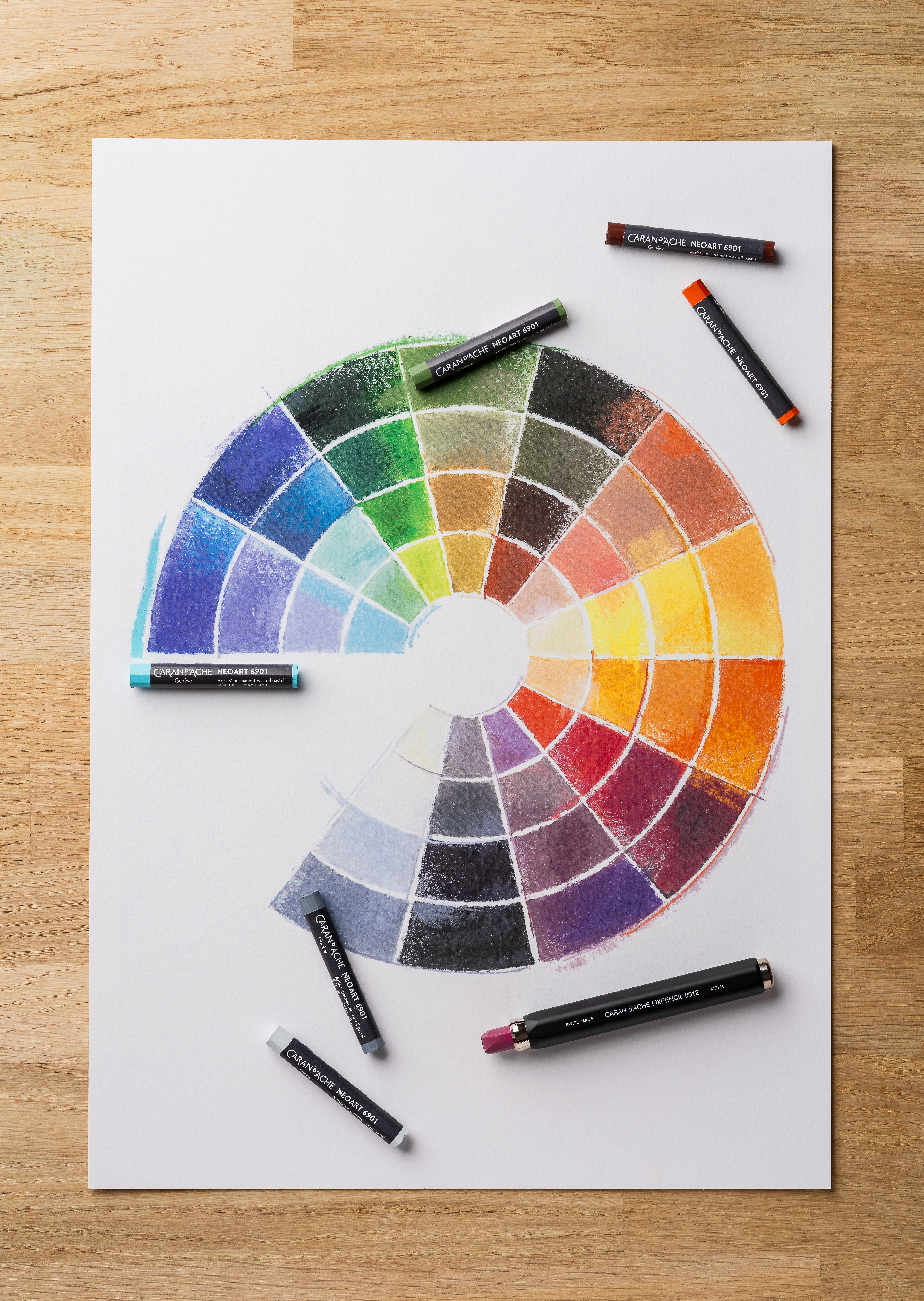 Colour wheel chart painted with Caran d’Ache Neoart 6901 wax oil pastels with pastel sticks arranged around the page
