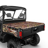 Can-Am Defender Tonneau Cover 715003048 in camo pattern fitted over the cargo box