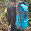 Man wearing the blue Sharkskin 30 L dry backpack outdoors