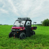 Red Can-Am Defender with Soft Doors and roof fitted, parked on grass