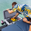 Man packing fruit and drinks into the open LinQ 43 L cooler on a boat