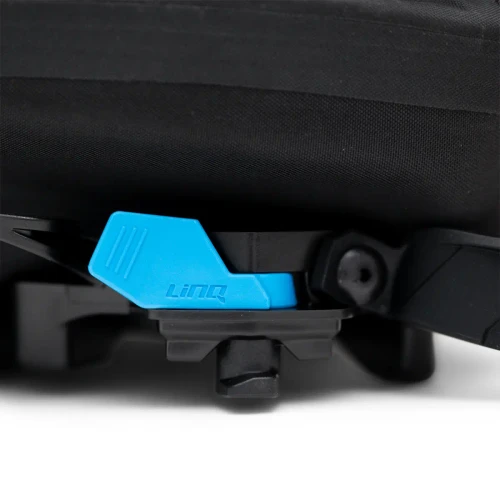 Close-up of the blue LinQ latch on the base of the roll-top bag