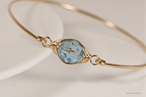 14k yellow gold filled wire wrapped bangle bracelet with aquamarine blue crystal handmade by Jessica Luu Jewelry