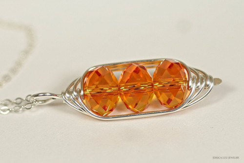 sterling silver wire wrapped pendant on chain necklace with tangerine orange crystal rondelles handmade by Jessica Luu Jewelry