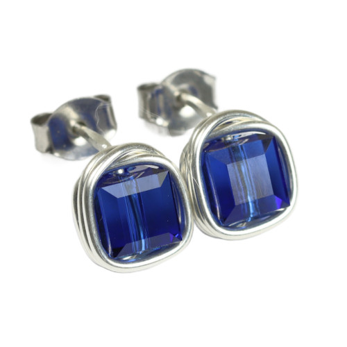 6mm faceted dark sapphire blue cube shaped Austrian crystal stud earrings in sterling silver wire wrapped setting handmade by Jessica Luu Jewelry 6mm faceted dark sapphire blue cube shaped Austrian crystal stud earrings in sterling silver wire wrapped setting handmade by Jessica Luu Jewelry