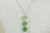 Sterling silver wire wrapped green ombre pendant on chain necklace with chrysolite, peridot, and fern green crystals handmade by Jessica Luu Jewelry