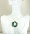 Christmas wreath pendant on gold chain necklace with emerald green crystals and multicolored pearl ornaments handmade by Jessica Luu Jewelry