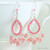 Teardrop shaped sterling silver chandelier earrings with peach pink Austrian crystals handmade by Jessica Luu Jewelry