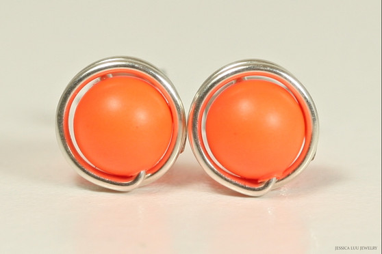 Sterling silver wire wrapped stud earrings with neon orange pearls handmade by Jessica Luu Jewelry