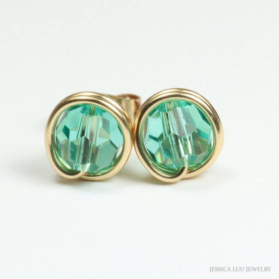6mm aqua green faceted round Austrian crystal stud earrings in 14K yellow gold filled wire wrapped setting handmade by Jessica Luu Jewelry