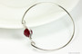 Sterling silver wire wrapped bangle bracelet with garnet red siam crystal handmade by Jessica Luu Jewelry