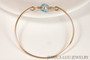14k yellow gold filled wire wrapped bangle bracelet with aquamarine blue crystal handmade by Jessica Luu Jewelry