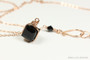 8mm jet black cube shaped Austrian crystal solitaire pendant in 14K rose gold filled wire wrapped setting hung on 18 inch long chain necklace handmade  by Jessica Luu Jewelry