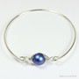 Sterling silver bangle bracelet with 10mm iridescent dark blue pearl solitaire handmade by Jessica Luu Jewelry