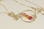 14K yellow gold filled wire wrapped paisley pendant on chain necklace with light rose, sunflower, and Indian pink crystals handmade by Jessica Luu Jewelry