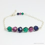 Sterling silver wire wrapped chain bracelet with green purple blue crystals handmade by Jessica Luu Jewelry