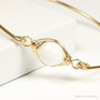 14K yellow gold filled wire wrapped bangle bracelet with 10mm white alabaster gemstone solitaire handmade by Jessica Luu Jewelry