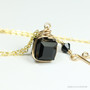 8mm black cube shaped Austrian crystal pendant in 14K yellow gold filled wire wrapped setting on 18 inch long chain necklace handmade by Jessica Luu Jewelry