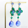 14K yellow gold filled earrings with faceted round emerald green Austrian crystals and sapphire blue teardrop shaped Austrian crystal dangles handmade by Jessica Luu Jewelry