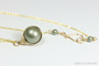 12mm sage green pearl solitaire in 14K yellow gold filled wire wrapped setting on 18 inch long chain necklace handmade by Jessica Luu Jewelry