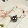 12mm black pearl solitaire in 14K rose gold filled wire wrapped setting on 18 inch long chain necklace handmade by Jessica Luu Jewelry