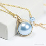 12mm light blue pearl solitaire in 14K yellow gold filled wire wrapped setting on 18 inch long chain necklace handmade by Jessica Luu Jewelry