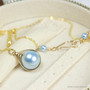 12mm light blue pearl solitaire in 14K yellow gold filled wire wrapped setting on 18 inch long chain necklace handmade by Jessica Luu Jewelry