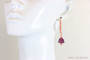 14K yellow gold filled dangle earrings with amethyst purple bell shaped Austrian crystals and long hook ear wires crusted with peachy pink Austrian crystals handmade by Jessica Luu Jewelry