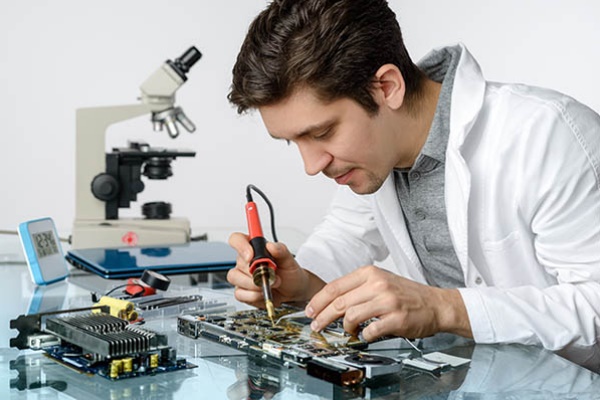 Technician repairing microscope