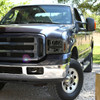 Spec-D Tuning F-250 Factory Style Headlights w/ Dual LED C-Bars - Chrome Housing, Smoked Lens (2005-2007)