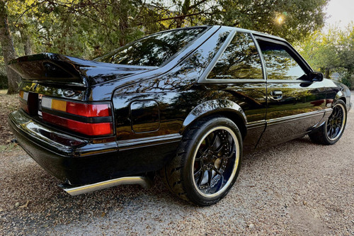 Steeda's original 307-0002 fiberglass rear aero spoiler for Fox Body 1979-1993 Mustangs, 307-0002-GF installed on black mustang