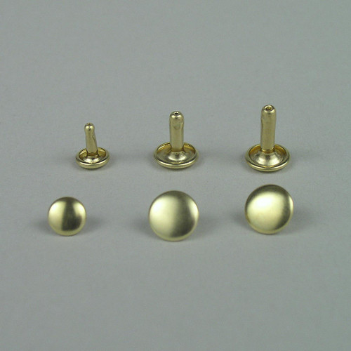 Size comparison of solid brass double cap rivets from left to right: small, medium, large