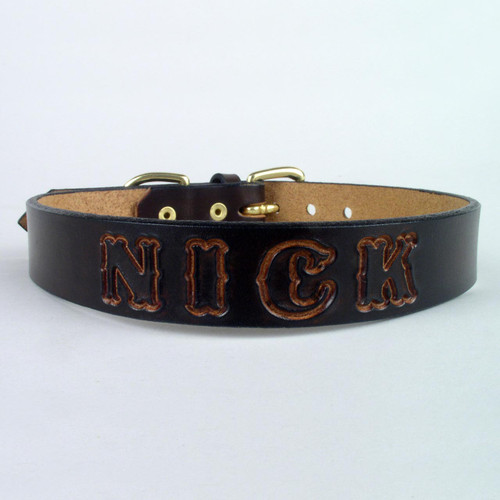 Custom dog collar made of solid leather and imprinted name shown in undyed lettering.