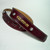 Yellow stitching borders edge with gold imprinted name in burgundy leather guitar strap.