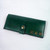 Green leather women's wallet with contrasting undyed lettering.