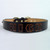 Custom dog collar made of solid leather and imprinted name shown in undyed lettering.