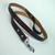 Six foot leather leash imprinted deep with white hand painted letters.