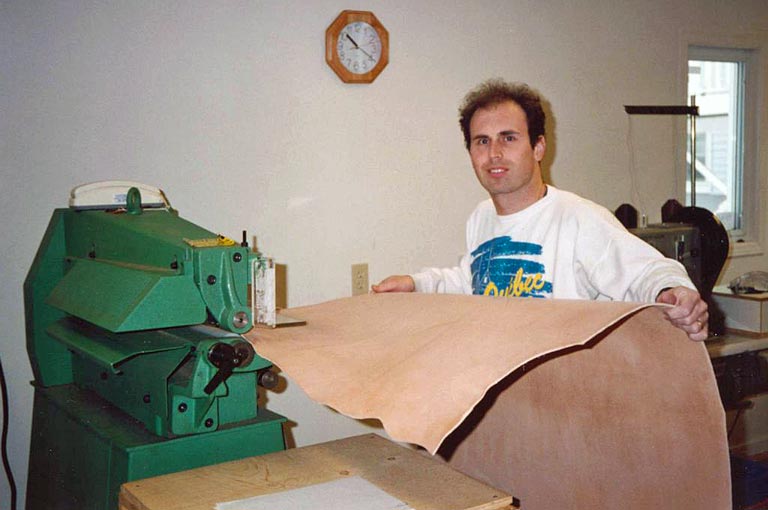 Jamie cutting belts on strap cutter machine.