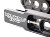 Roaring Toyz Bolt-On Swingarm Extensions Kawasaki ZX14R (06-26), close-up of the black metallic extension with white logo and bolt mechanism for motorcycle modification. Roaring Toyz Bolt-On Swingarm Extensions Kawasaki ZX14R (06-26), close-up of the black metallic extension with white logo and bolt mechanism for motorcycle modification.