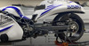 DME Aluminum Swingarm Suzuki Hayabusa (08-21), close-up of the black aluminum swingarm attached to a motorcycle with blue and white bodywork, showing detailed construction and chain drive system.