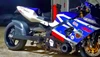 DME Aluminum Swingarm Suzuki GSXR1000, motorcycle with blue and white fairings and various decals parked on a concrete surface.