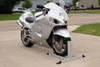 Condor Pit Stop/Trailer Wheel Chock, silver motorcycle wheel chock securing a motorcycle on a concrete surface.