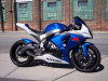 VooDoo Shorty Slip On Exhaust Suzuki GSXR1000 (07-08), sleek blue and white sport motorcycle parked on street with urban background.