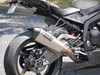 Brocks Performance Brocks CT Single Full Exhaust 16" Muffler BMW S1000RR (10-14), showing a sleek, silver motorcycle exhaust with the Brocks logo, attached to a high-performance sportbike.