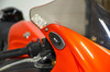 Brocks Performance Brocks Carbon Fiber Mirror Block Off Plates Suzuki Hayabusa (99-20), close-up of the carbon fiber mirror block off plates on a red Suzuki Hayabusa motorcycle with the windshield in the background.