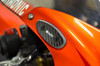 Brocks Performance Brocks Carbon Fiber Mirror Block Off Plates Suzuki Hayabusa (99-20), close-up view of the carbon fiber mirror block off plate installed on the orange motorcycle's handlebar area.