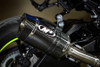 M4 Performance Exhausts M4 Tech1 Carbon Exhaust Suzuki GSXR1000 (17-25) with Titanium Midpipe, close-up view of the motorcycle exhaust system featuring a sleek black carbon fiber muffler with a logo, mounted on a Suzuki GSXR1000.