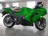 RCC Turbo Kit Stage 1 Kawasaki ZX14R (12-25), vibrant green Kawasaki Ninja sport motorcycle with aerodynamic fairings and black accents displayed indoors.