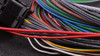 MaxxECU V1/Race/Pro Flying Lead Wiring Harness Connector, close-up of a bundle of multicolored electrical wiring harnesses with multiple wires connected.